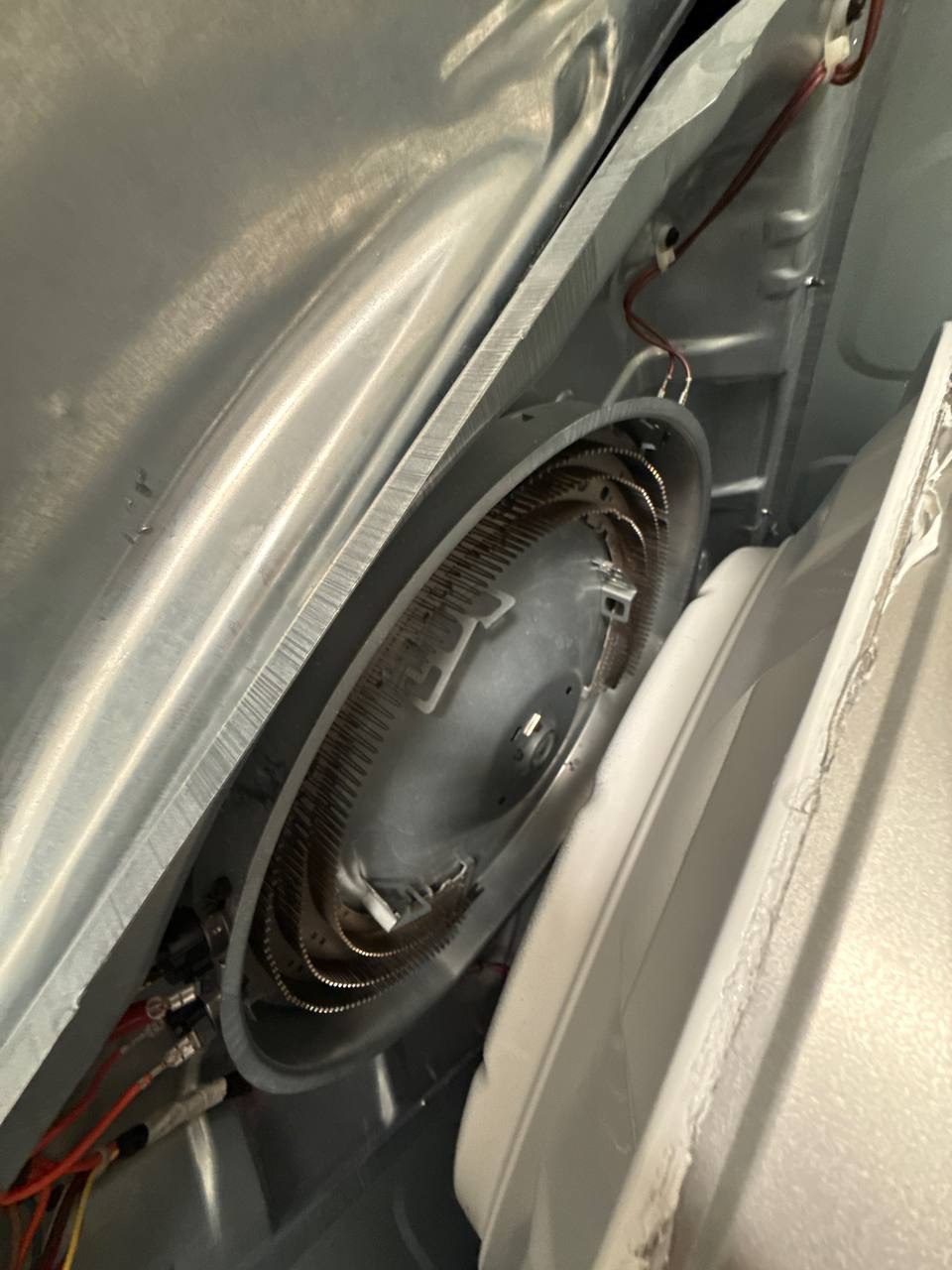 Dryer opened to expose heating element for repair in a Naples home
